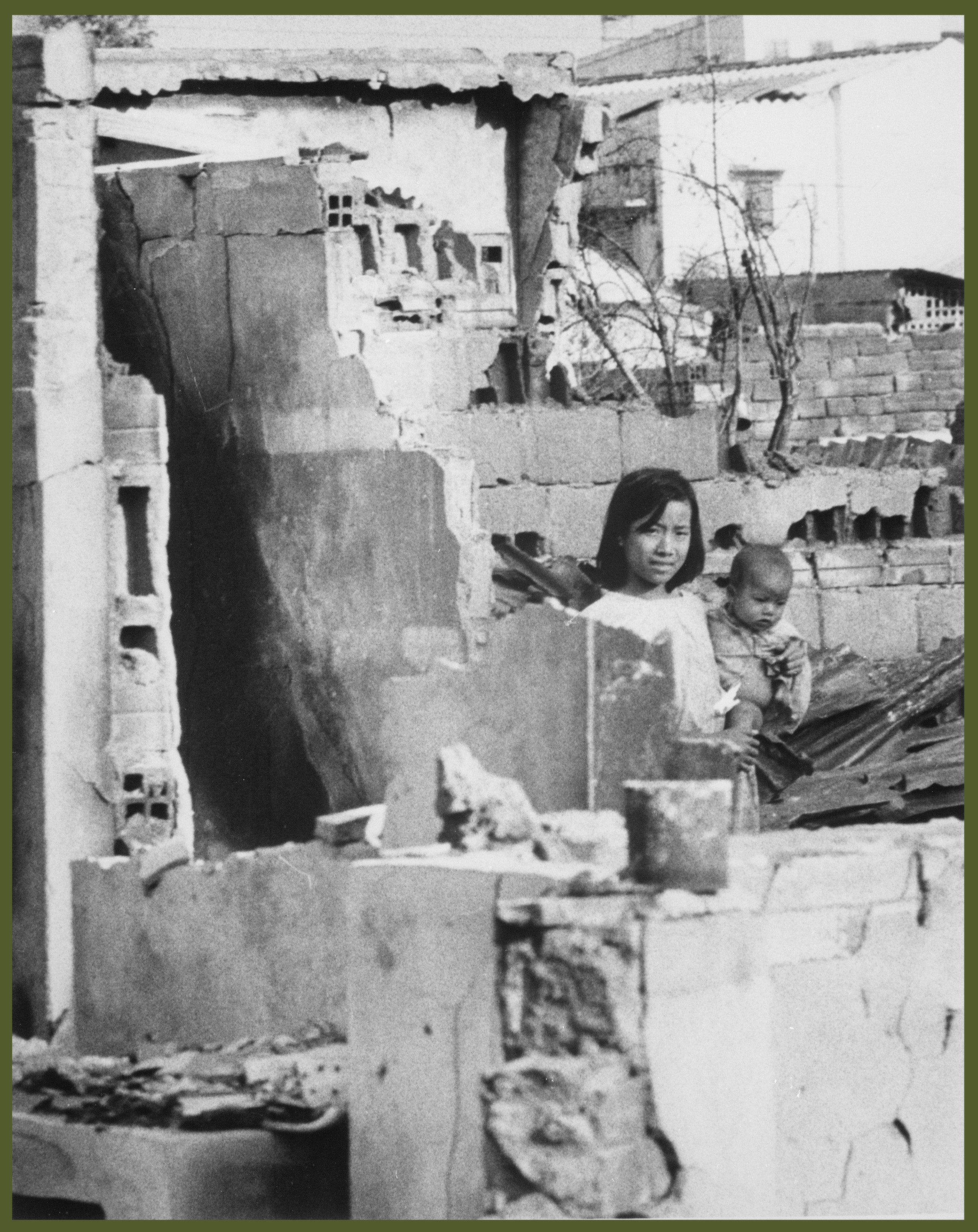A girl, holding a small child