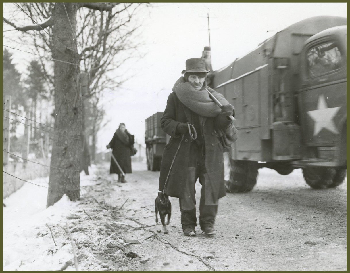 Belgian Civilians Walk Along a Road in Lierneux, Belgium