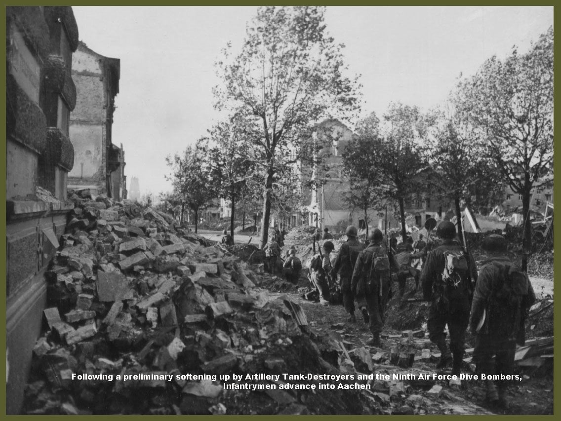 Following A Preliminary Softening Up By Artillery Tank-Destroyers And 9Th Af Dive Bombers Yank Infantrymen Are Shown Advancing Into The City Of Aachen, Germany
