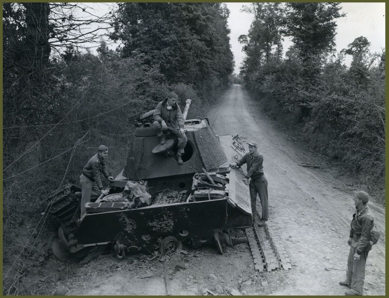 P-47 pilots look over the result of their accurate and deadly fire to a knocked out German Panther tank, somewhere in France.