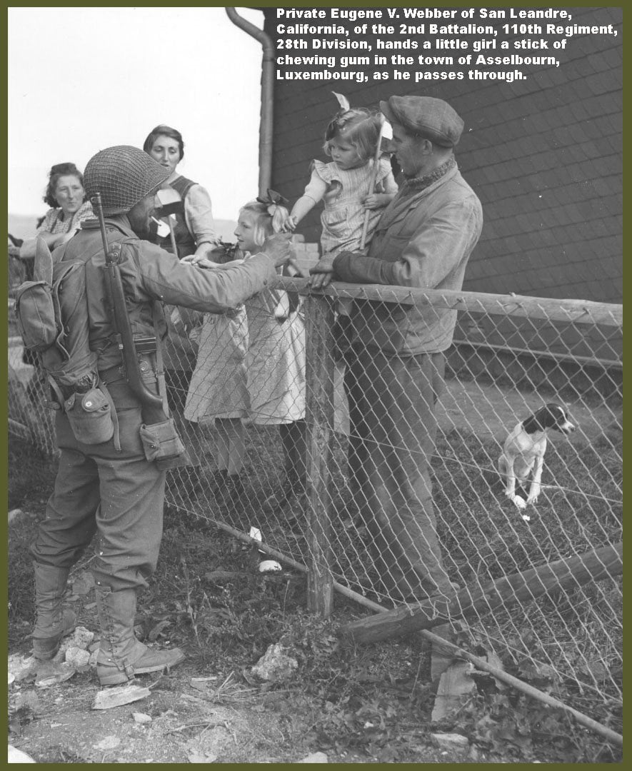 Private Eugene V. Webber Handing a Little Girl a Stick of Chewing Gum in the Town of Asselbourn, Luxemburg