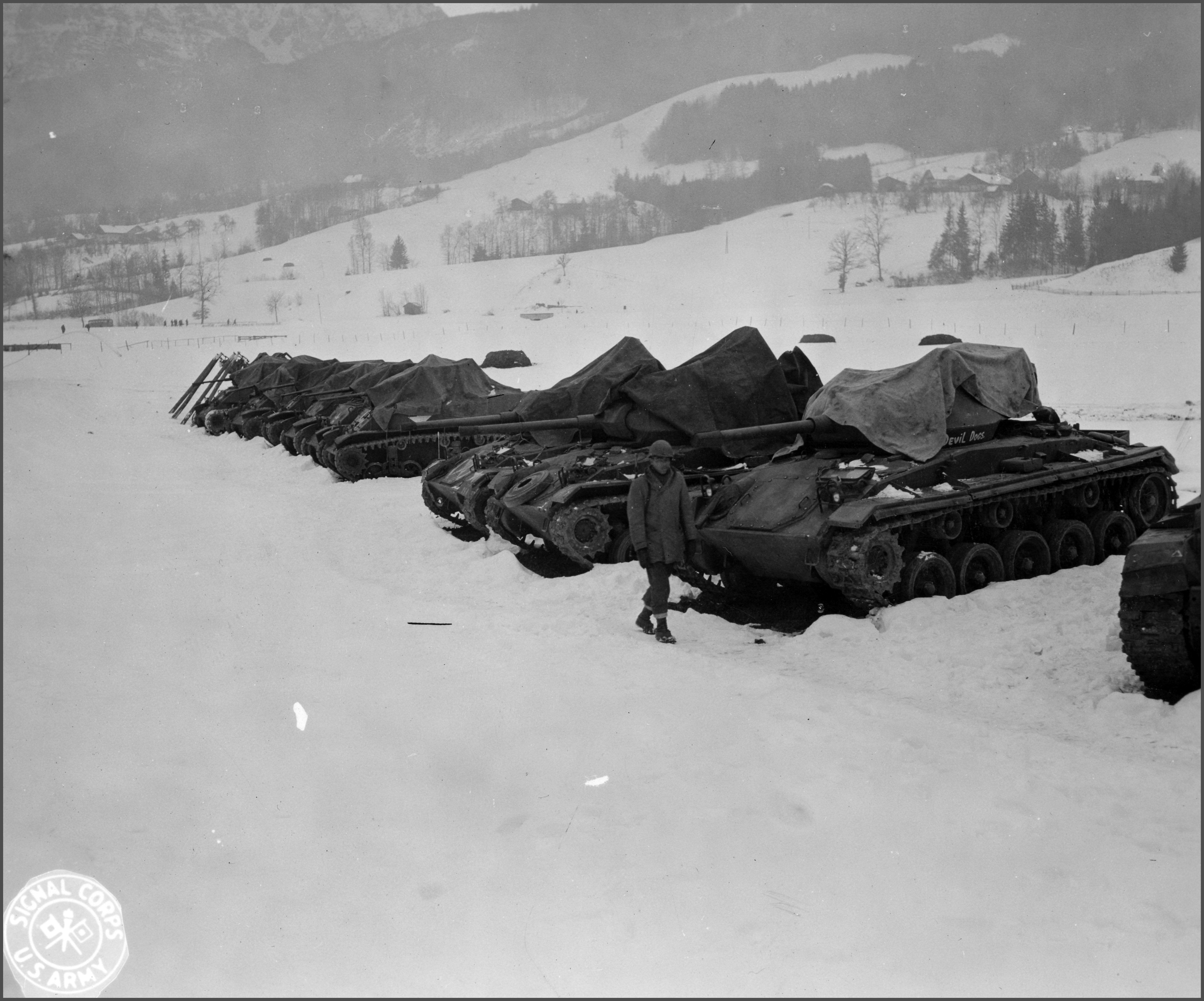 Pvt. Eugene Hamilton of Huntington, L.I., guards the Bn.s tanks. Munich area, Germany.